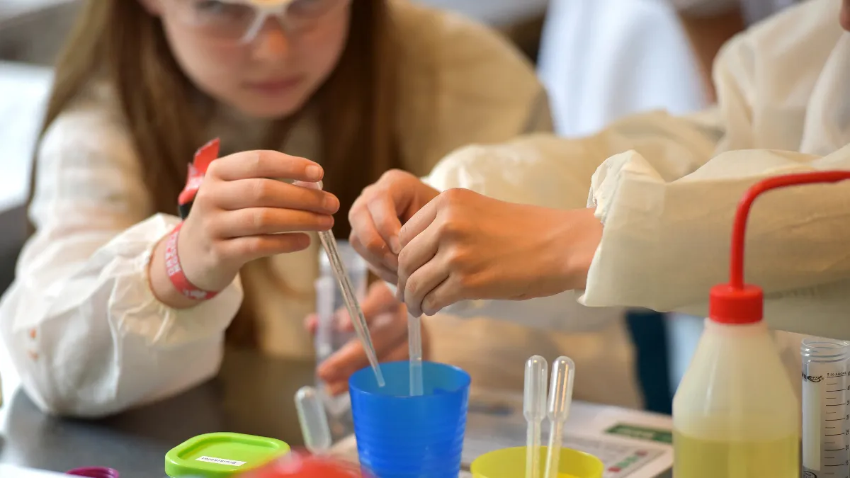 Child conducting a simple home science experiment with parent
